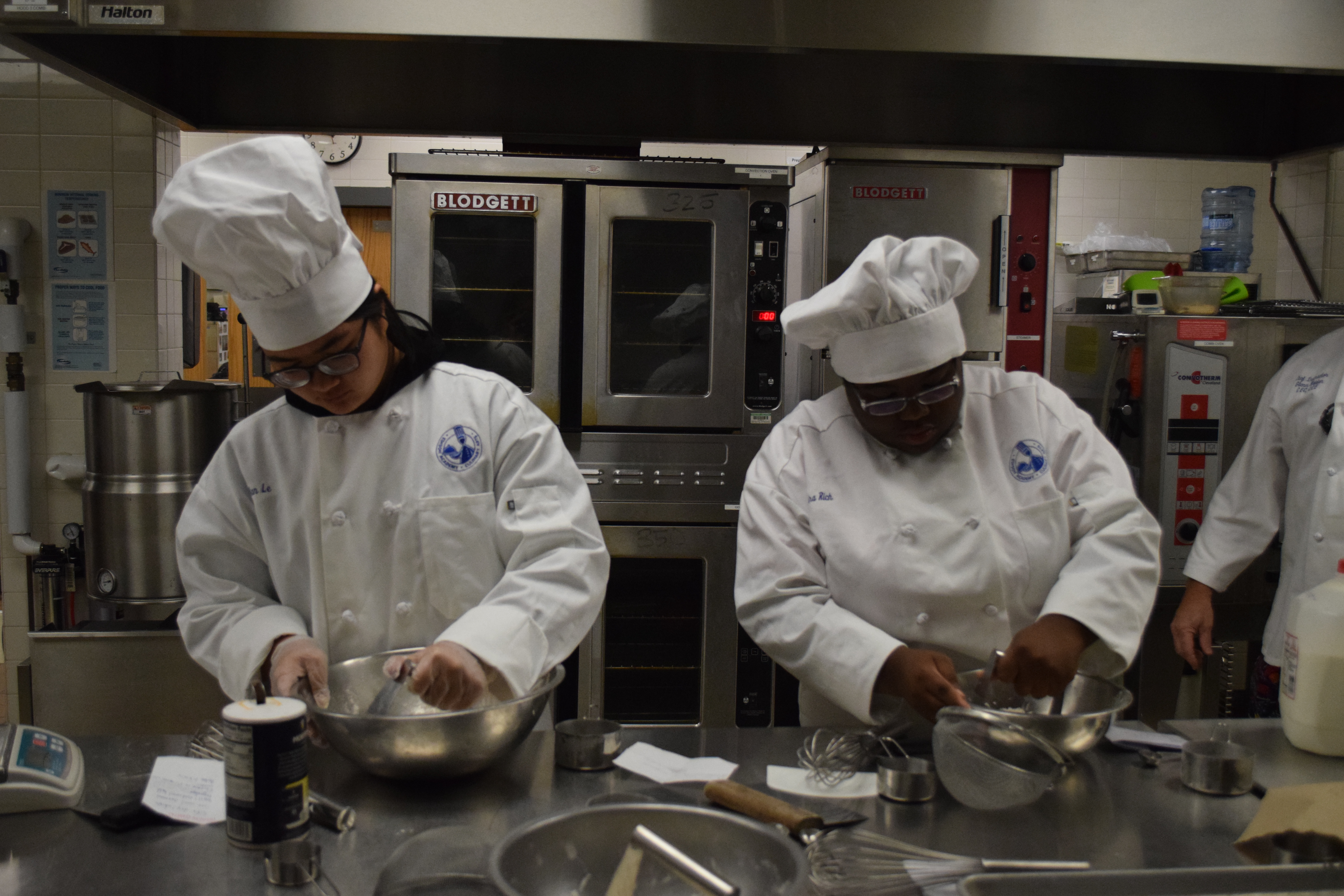 Culinary students preparing Bistro meals for take out orders.