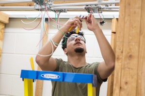 Kevin Cruz Lovo a Graduate of Electrical at work with FCPS Facilities