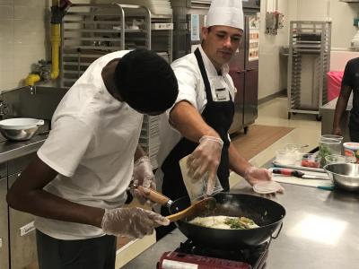 Culinary Arts II student cooks with Chef Jeff from JWU