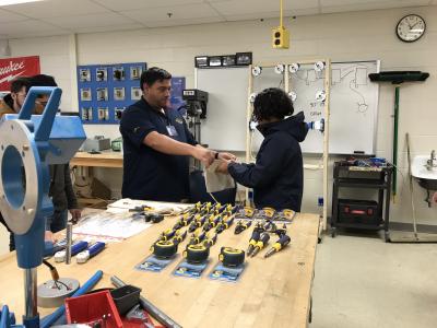 ECE student accepting his tool prizes from instructor,  J. Wolfe