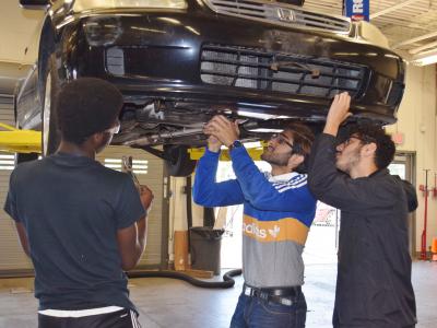 Automotive Technology students demonstrate  auto maintenance in their lab/shop.  