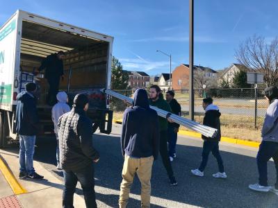 Students unloading donated materials