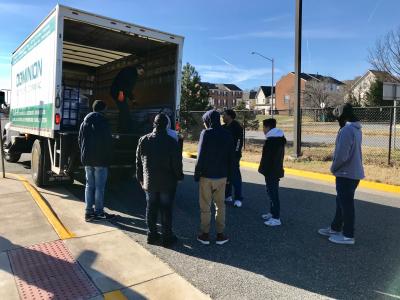 students unloading electrical program materials from a truck