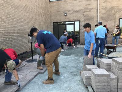 Students building walkways to the fire pit and amphitheater.