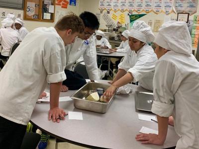 Another Culinary Team brainstorming with their mystery ingredient basket. 